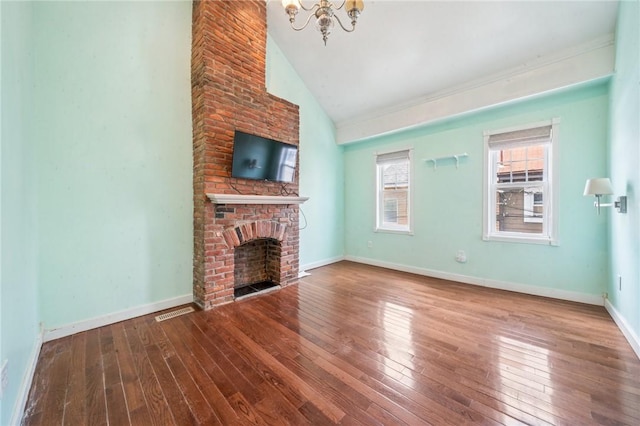 324 Orwell Way, Bloomfield, PA 15224 - unfurnished living room with vaulted ceiling, a chandelier, wood-type flooring, a fireplace, and ornamental molding