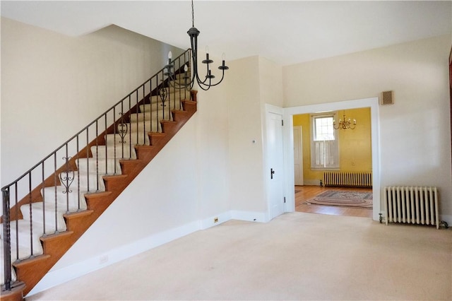 322 Garfield Ave, Mars Boro, PA 16046 - stairway featuring radiator, a chandelier, baseboards, and carpet