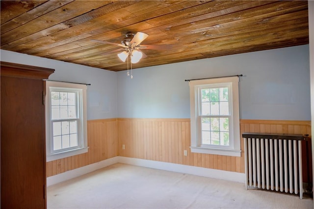 322 Garfield Ave, Mars Boro, PA 16046 - unfurnished room featuring wood ceiling, a wainscoted wall, a ceiling fan, radiator heating unit, and wooden walls