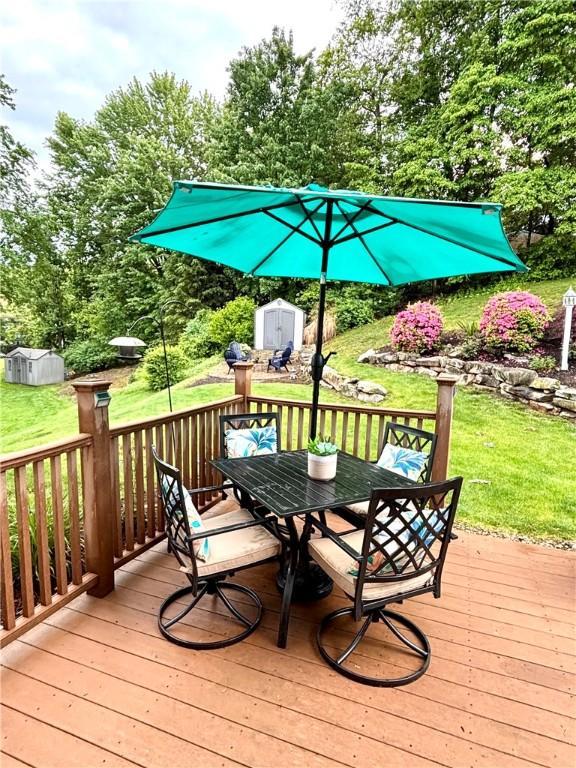 112 Bandywine, Penn Twp Wml, PA 15642 - wooden deck featuring outdoor dining area, a yard, and view of scattered trees