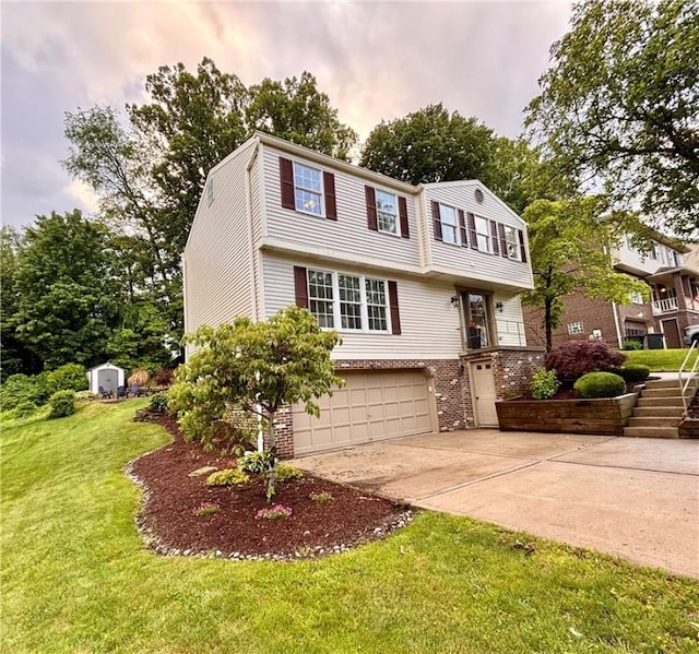 112 Bandywine, Penn Twp Wml, PA 15642 - colonial-style house featuring a garage, driveway, brick siding, a front lawn, and a shed