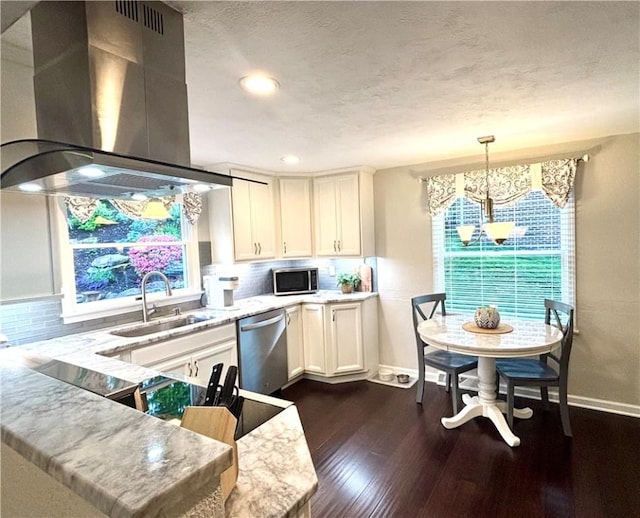 112 Brandywine, Manor, PA 15642 - kitchen with island range hood, stainless steel appliances, a sink, a chandelier, and decorative backsplash