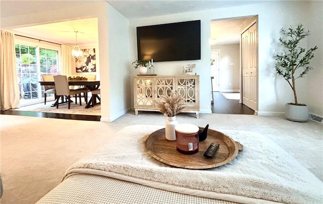 112 Bandywine, Penn Twp Wml, PA 15642 - carpeted living room featuring baseboards and a chandelier