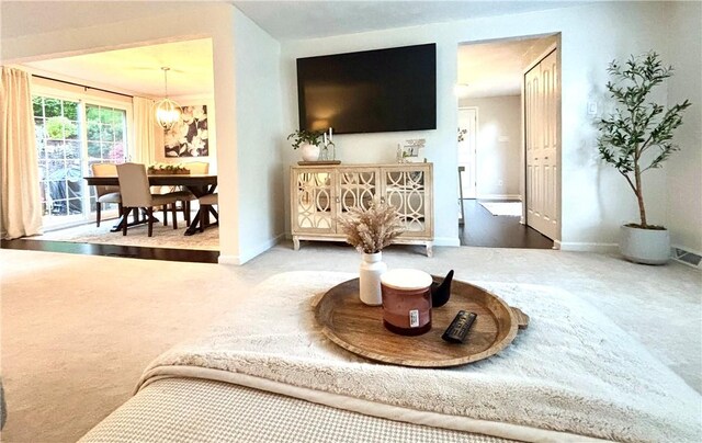 112 Brandywine, Manor, PA 15642 - carpeted living room with baseboards and a chandelier