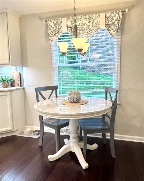 112 Bandywine, Penn Twp Wml, PA 15642 - dining space with dark wood-type flooring, baseboards, and a chandelier
