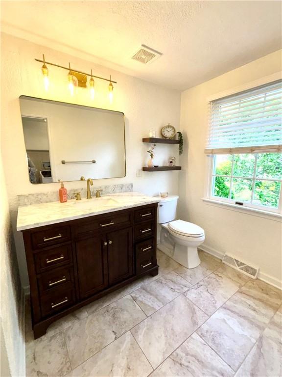 112 Bandywine, Penn Twp Wml, PA 15642 - bathroom with vanity, toilet, a textured ceiling, and baseboards