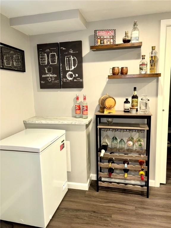 112 Bandywine, Penn Twp Wml, PA 15642 - laundry room with wood finished floors, a dry bar, and baseboards