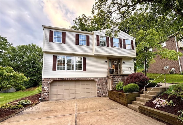 112 Brandywine, Manor, PA 15642 - colonial-style house with an attached garage, driveway, and brick siding