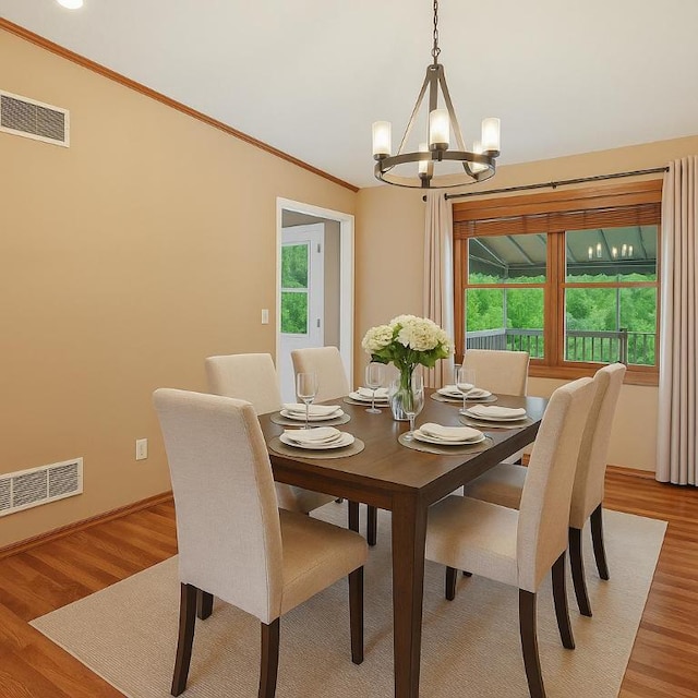 465 Hewitt Ave, Canton Twp, PA 15301 - dining room featuring a chandelier, crown molding, light wood-style floors, and baseboards