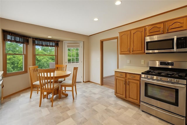 465 Hewitt Ave, Canton Twp, PA 15301 - kitchen featuring appliances with stainless steel finishes, baseboards, light countertops, brown cabinetry, and recessed lighting