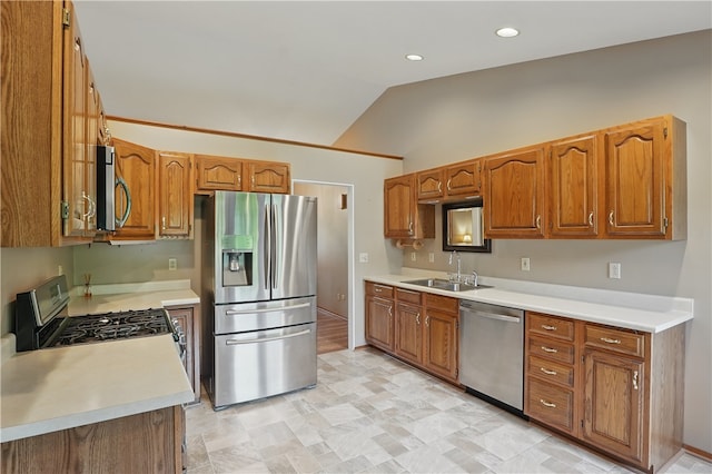 465 Hewitt Ave, Canton Twp, PA 15301 - kitchen featuring appliances with stainless steel finishes, a sink, vaulted ceiling, brown cabinets, and light countertops