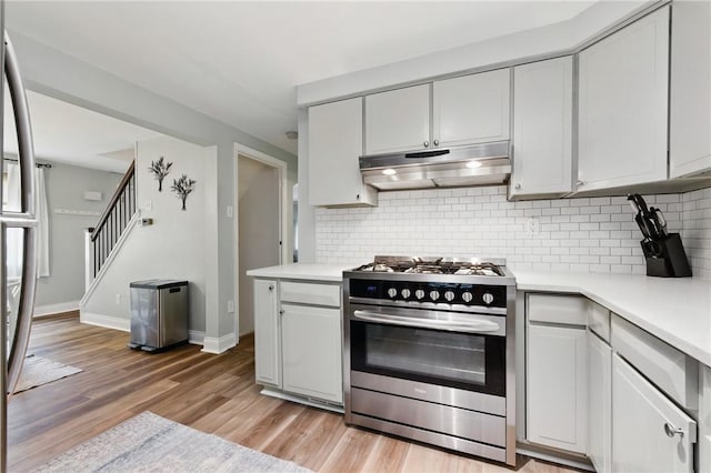 471 Filmore Rd, Forest Hills Boro, PA 15221 - kitchen featuring stainless steel range with gas cooktop, under cabinet range hood, light countertops, and light wood-type flooring