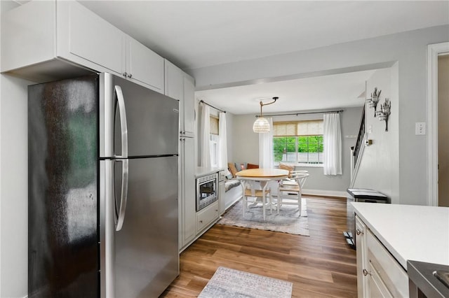 471 Filmore Rd, Forest Hills Boro, PA 15221 - kitchen with freestanding refrigerator, light countertops, wood finished floors, and white cabinets