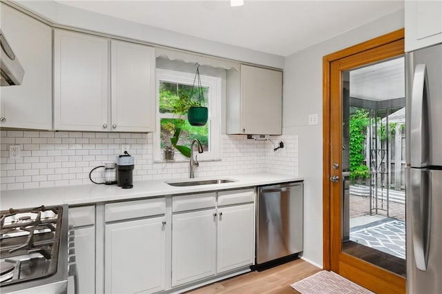 471 Filmore Rd, Forest Hills Boro, PA 15221 - kitchen with appliances with stainless steel finishes, a sink, light countertops, light wood-style floors, and plenty of natural light