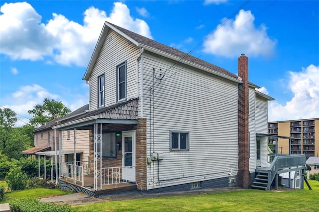 208 Maple Ave, City Of But Se, PA 16001 - view of side of property featuring a chimney and a lawn