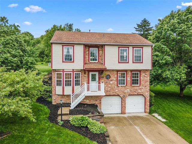 300 Green Flds, Cranberry Twp, PA 16066 - colonial house featuring a garage, concrete driveway, brick siding, and a front lawn