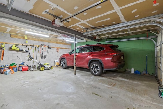 300 Green Flds, Cranberry Twp, PA 16066 - garage featuring a garage door opener and concrete block wall
