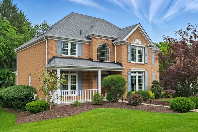 2536 Appletree Dr, Upper St Clair, PA 15241 - view of front of property with covered porch, brick siding, a front yard, and a shingled roof