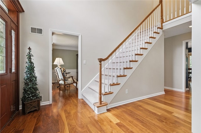 2536 Appletree Dr, Upper St Clair, PA 15241 - entrance foyer featuring wood finished floors, stairs, a towering ceiling, crown molding, and baseboards