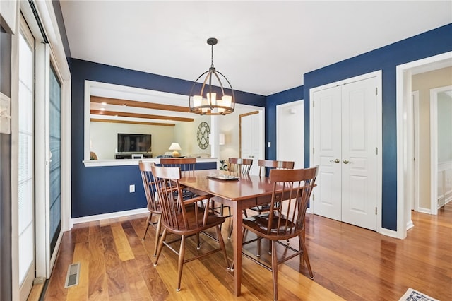 2536 Appletree Dr, Upper St Clair, PA 15241 - dining area with light wood finished floors, a chandelier, and baseboards