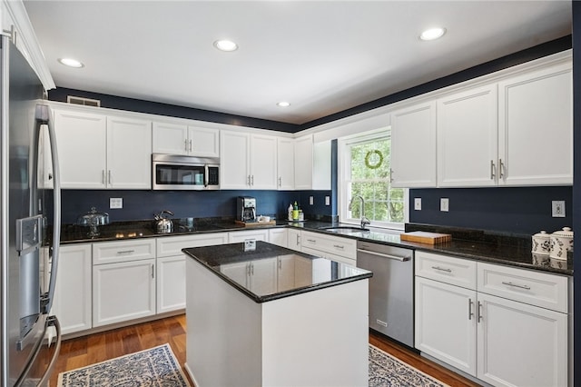 2536 Appletree Dr, Upper St Clair, PA 15241 - kitchen with stainless steel appliances, a sink, white cabinets, wood finished floors, and dark stone countertops