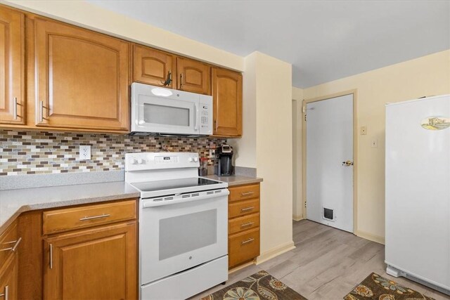 53 Escalon Dr, Findlay Twp, PA 15108 - kitchen with white appliances, light wood-type flooring, tasteful backsplash, light countertops, and brown cabinetry