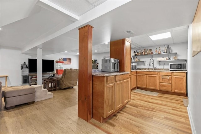53 Escalon Dr, Findlay Twp, PA 15108 - kitchen with stainless steel microwave, light wood-style floors, a sink, open shelves, and light countertops