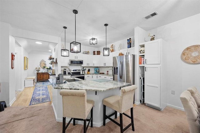 200 Hidden Ridge Ct Unit 202, South Park, PA 15129 - kitchen with stainless steel appliances, a sink, open shelves, a breakfast bar area, and light stone countertops