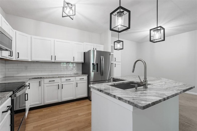 200 Hidden Ridge Ct Unit 202, South Park, PA 15129 - kitchen with stainless steel appliances, decorative backsplash, light stone counters, white cabinets, and decorative light fixtures
