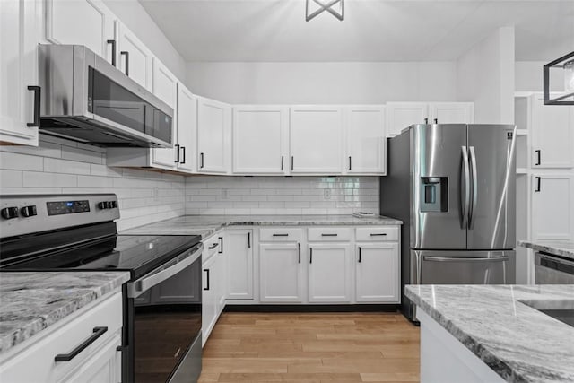 200 Hidden Ridge Ct Unit 202, South Park, PA 15129 - kitchen with stainless steel appliances, light wood-style flooring, white cabinetry, light stone counters, and decorative backsplash
