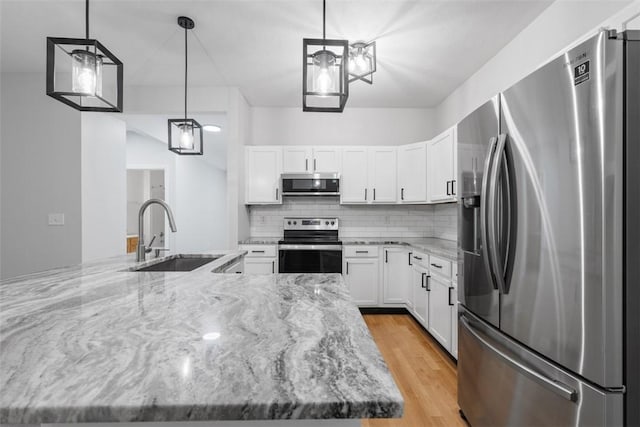 200 Hidden Ridge Ct Unit 202, South Park, PA 15129 - kitchen with appliances with stainless steel finishes, decorative backsplash, white cabinets, and light stone counters