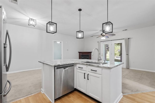 200 Hidden Ridge Ct Unit 202, South Park, PA 15129 - kitchen featuring stainless steel appliances, a fireplace, ceiling fan, open floor plan, and light stone countertops