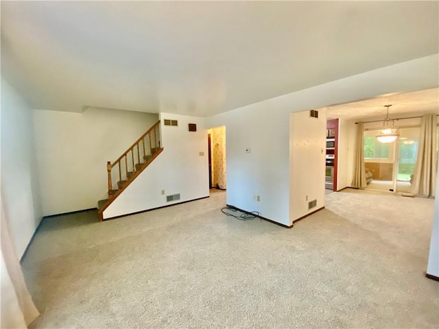 109 Parkside Dr, West Mifflin, PA 15122 - unfurnished living room with stairway, carpet flooring, and baseboards