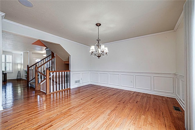 250 Overlook Ct, Robinson Twp Nwa, PA 15108 - spare room with ornamental molding, a chandelier, wood finished floors, stairs, and a decorative wall