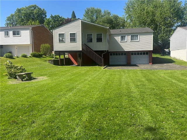 127 Opal Ct, Natrona Hts/Harrison Twp, PA 15065 - rear view of property with an attached garage, driveway, a lawn, and stairs
