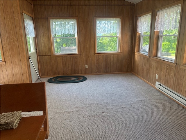 127 Opal Ct, Natrona Hts/Harrison Twp, PA 15065 - carpeted empty room featuring healthy amount of natural light, wooden walls, a baseboard heating unit, and baseboards