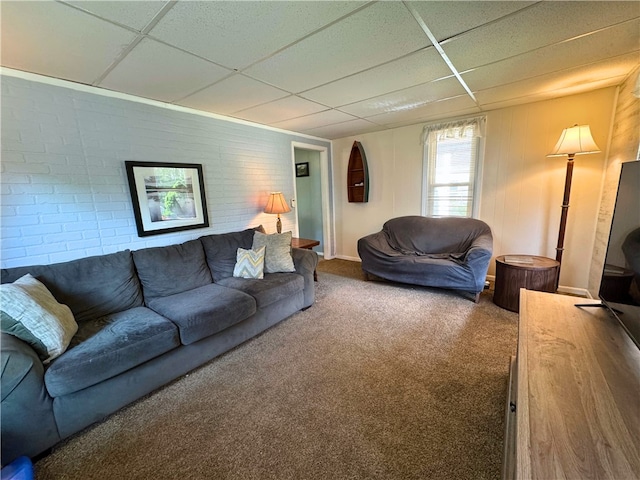 27 Oak Hill Dr, Pine Twp Mer, PA 16127 - living room featuring a paneled ceiling, brick wall, carpet floors, and baseboards