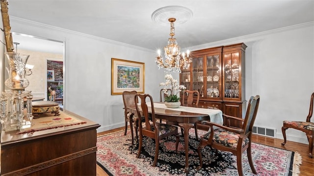 817 Wainwright Dr, Mt Lebanon, PA 15228 - dining space with a chandelier, ornamental molding, baseboards, and wood finished floors