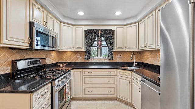 817 Wainwright Dr, Mt Lebanon, PA 15228 - kitchen featuring appliances with stainless steel finishes, a sink, cream cabinetry, backsplash, and recessed lighting