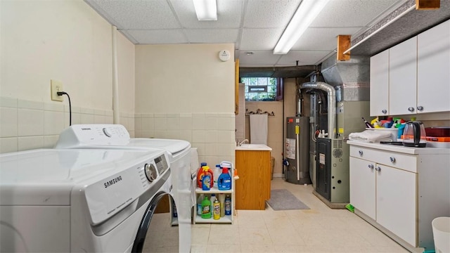 817 Wainwright Dr, Mt Lebanon, PA 15228 - washroom with independent washer and dryer, cabinet space, water heater, tile walls, and light floors
