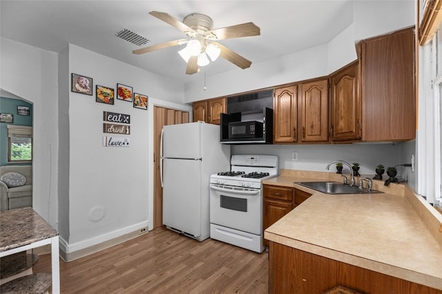 329 Ivondale St, Greenfield, PA 15207 - kitchen featuring white appliances, a sink, a ceiling fan, and brown cabinets