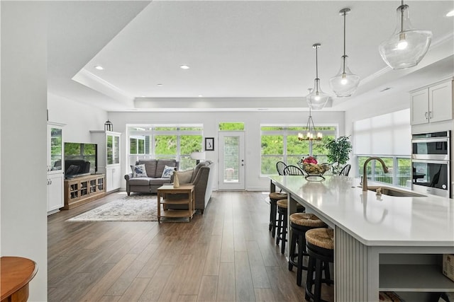 2019 Aiken Ct, Robinson Twp Nwa, PA 15136 - living room featuring dark wood-type flooring, plenty of natural light, a tray ceiling, and recessed lighting
