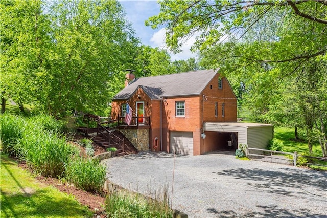 105 Brookwood Rd, Peters Twp, PA 15367 - view of home's exterior featuring a garage, gravel driveway, a chimney, stairs, and brick siding