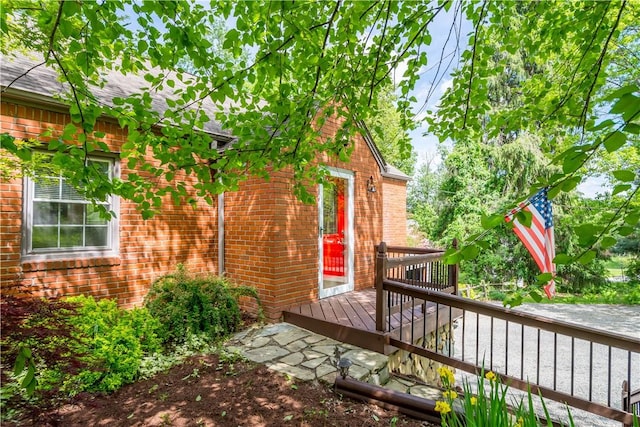 105 Brookwood Rd, Peters Twp, PA 15367 - view of exterior entry featuring a deck, brick siding, and roof with shingles