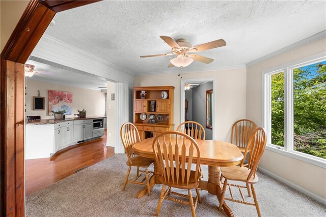 842 Towercrest Dr, Mt Lebanon, PA 15228 - dining space featuring ceiling fan, light colored carpet, ornamental molding, a textured ceiling, and baseboards