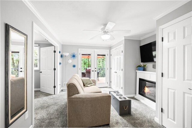842 Towercrest Dr, Mt Lebanon, PA 15228 - carpeted living room featuring french doors, baseboards, crown molding, ceiling fan, and a glass covered fireplace