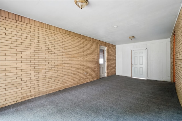 349 State Ave, Beaver, PA 15009 - unfurnished living room featuring brick wall, dark carpet, and wood walls