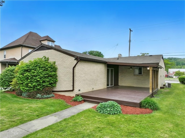 349 State Ave, Beaver, PA 15009 - rear view of house with a wooden deck, brick siding, a yard, and cooling unit