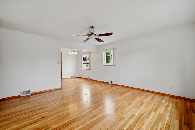 349 State Ave, Beaver, PA 15009 - unfurnished room with ceiling fan, baseboards, light wood-style floors, and a chandelier