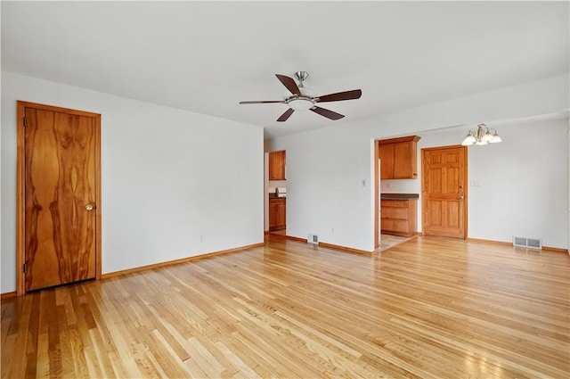 349 State Ave, Beaver, PA 15009 - unfurnished living room with light wood-type flooring, a ceiling fan, a chandelier, and baseboards